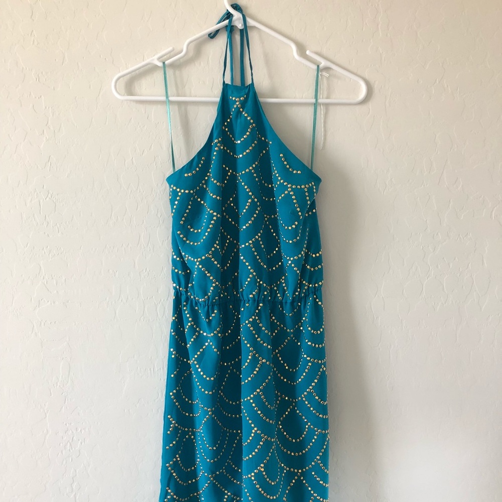 Deep turquoise blue, gold studded dress.